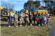 Group Posing with Shovels for Digging Ground Breaking